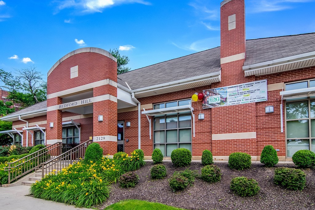 The front of a brick building with a sign that reads "Bridgton Hill".