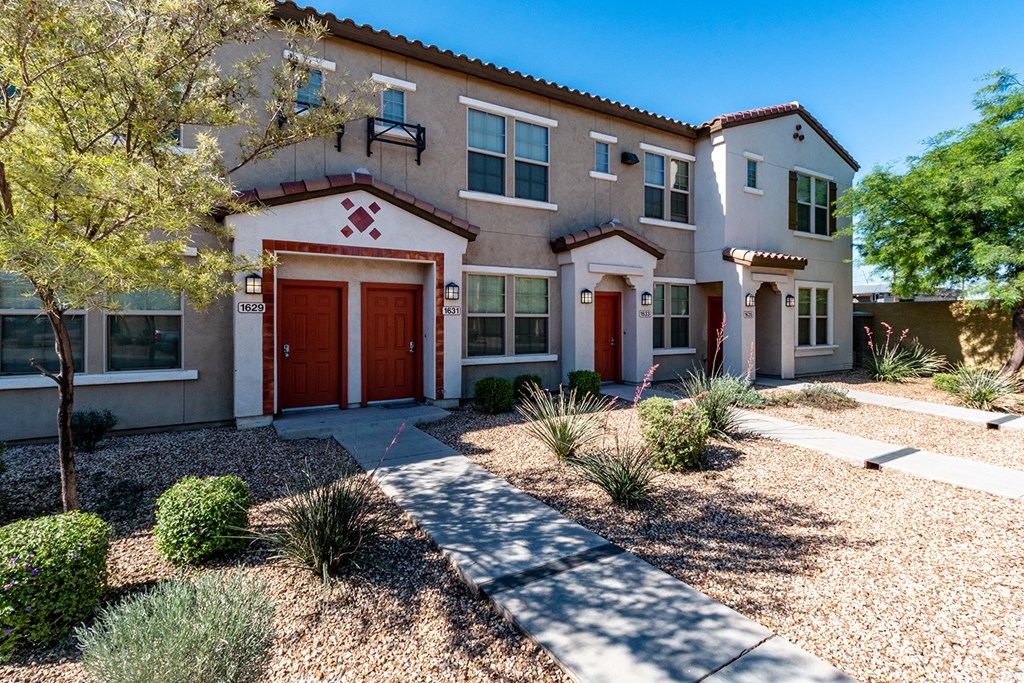 A house with a red garage door and a red window.