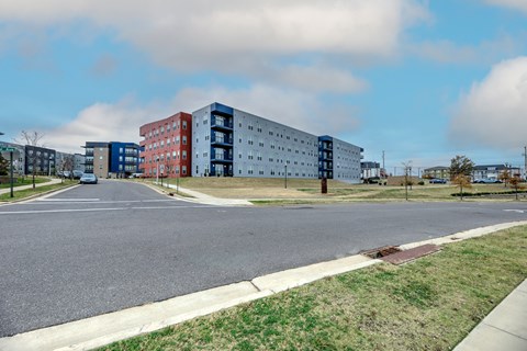 A street view of a residential area with multi-story buildings.