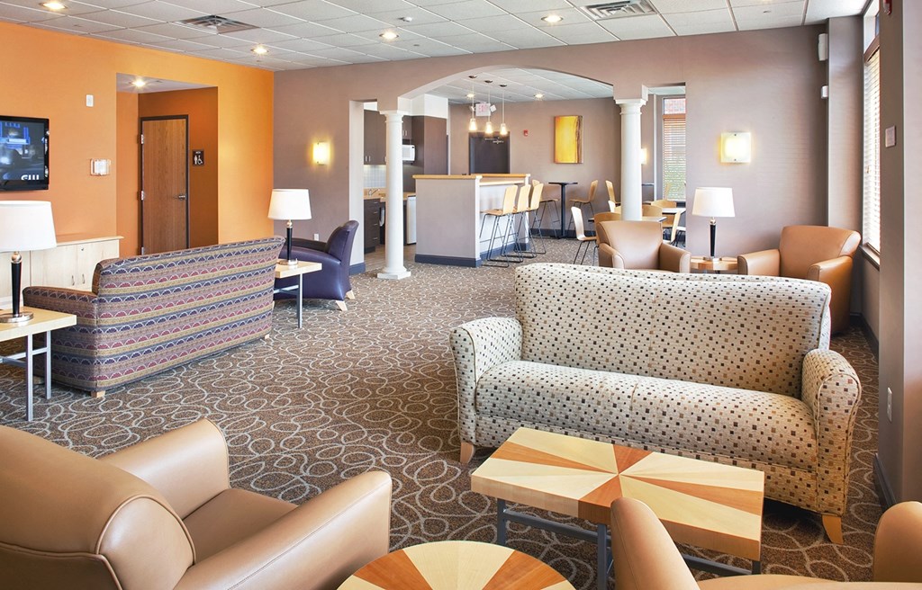 a lobby with couches and chairs and a reception desk