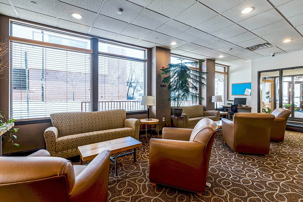 A large room with leather chairs and tables.