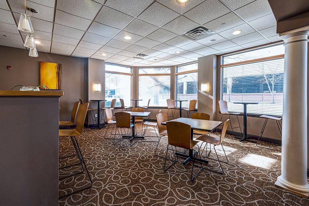 A conference room with a carpeted floor and a long table with chairs.