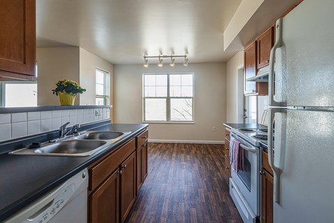 A kitchen with wooden cabinets and a white refrigerator.