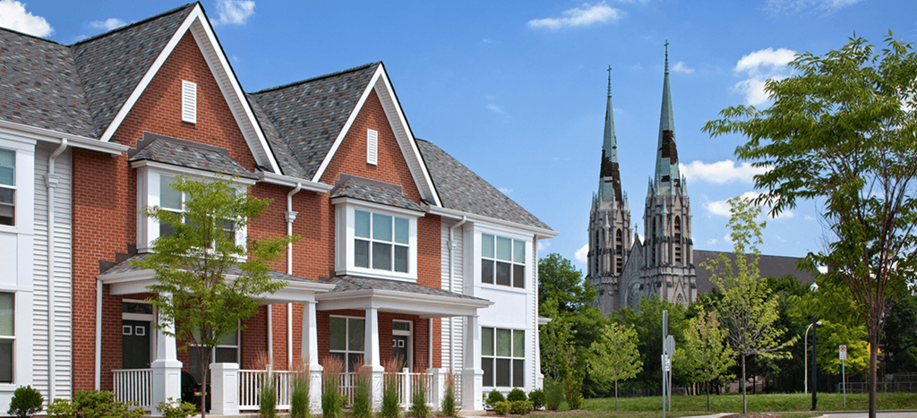 an apartment home with a church in the background