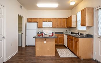 a kitchen with wooden cabinets and a white refrigerator