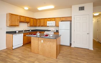 a kitchen with white appliances and wooden cabinets
