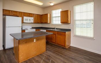 a kitchen with wooden cabinets and a white refrigerator