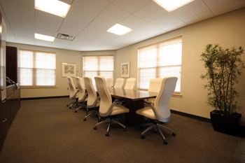 an empty conference room with a table and chairs