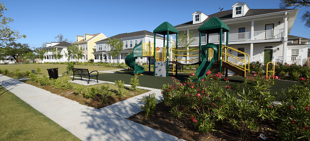 a playground in a park in front of Harmony Oaks Apartments