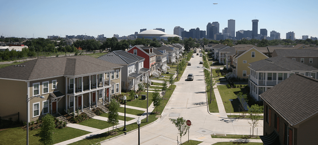 a row of apartment homes with the skyline in the background