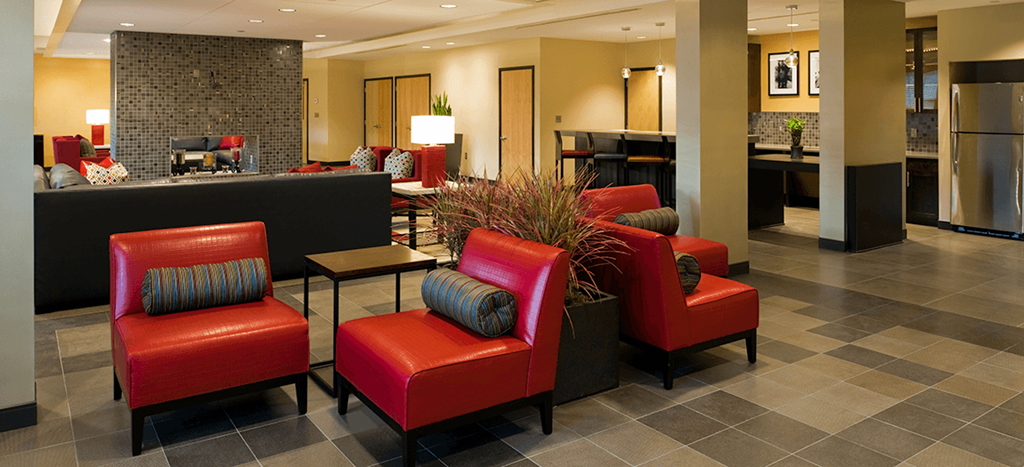 the clubhouse of Harmony Oaks Apartments with red chairs
