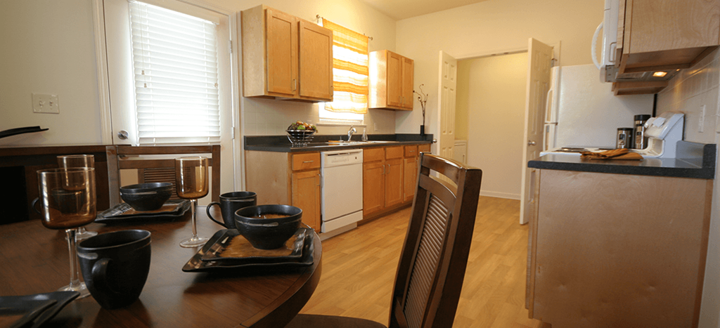 a kitchen and dining room with a table and chairs