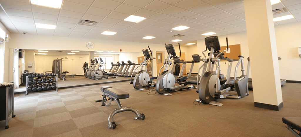a gym with a lot of exercise equipment