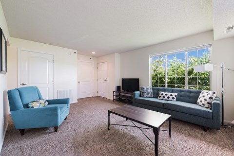 a living room with a blue couch and a coffee table