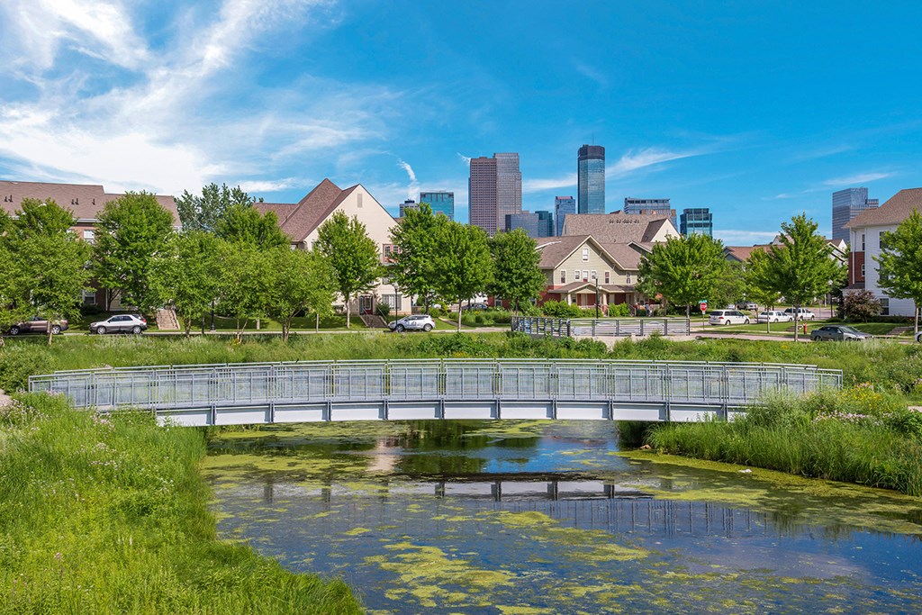 a bridge over a body of water with a city in the background