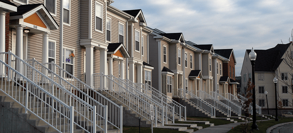 a row of apartment homes with metal railings at Heritage Park Apartments