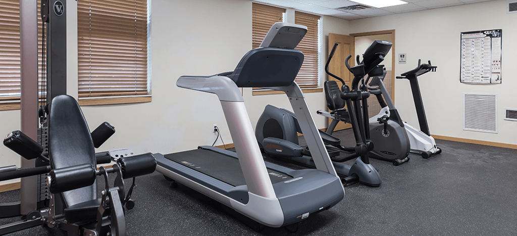 a gym with treadmills and other exercise equipment at Heritage Park Apartments
