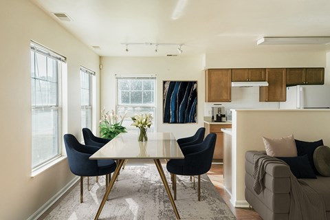 a living area with a dining table and a kitchen at Horace Mann apartments and townhomes in Gary, IN
