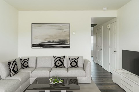 a living room with a couch and a coffee table at Horace Mann apartments and townhomes in Gary, IN