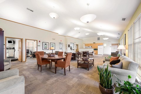 Community room with seating areas and a kitchenette at Horace Mann apartments and townhomes in Gary, IN