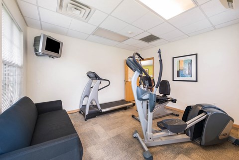 the gym has cardio equipment and a tv at Horace Mann apartments and townhomes in Gary, IN