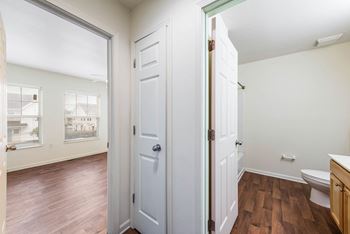 a bathroom with white doors and a toilet and a window at Horace Mann apartments and townhomes in Gary, IN
