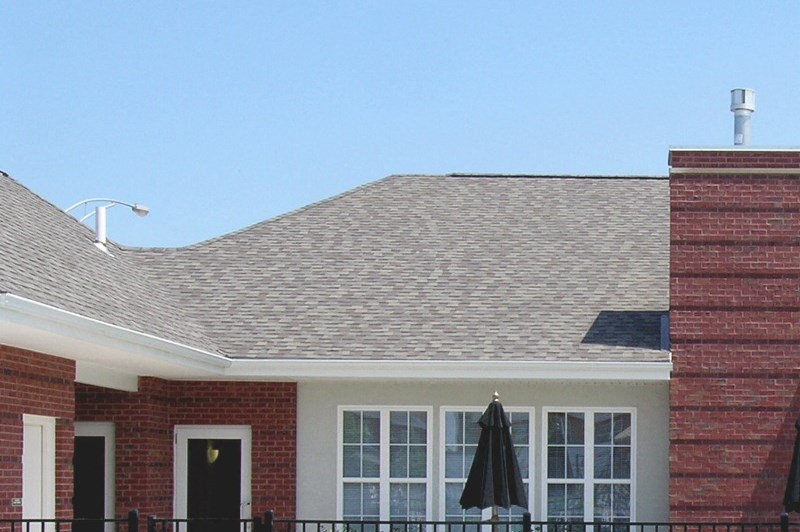 The leasing office with a swimming pool in front of it at Horace Mann apartments and townhomes in Gary, IN