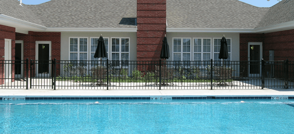 a swimming pool in front of Horace Mann Apartments leasing office