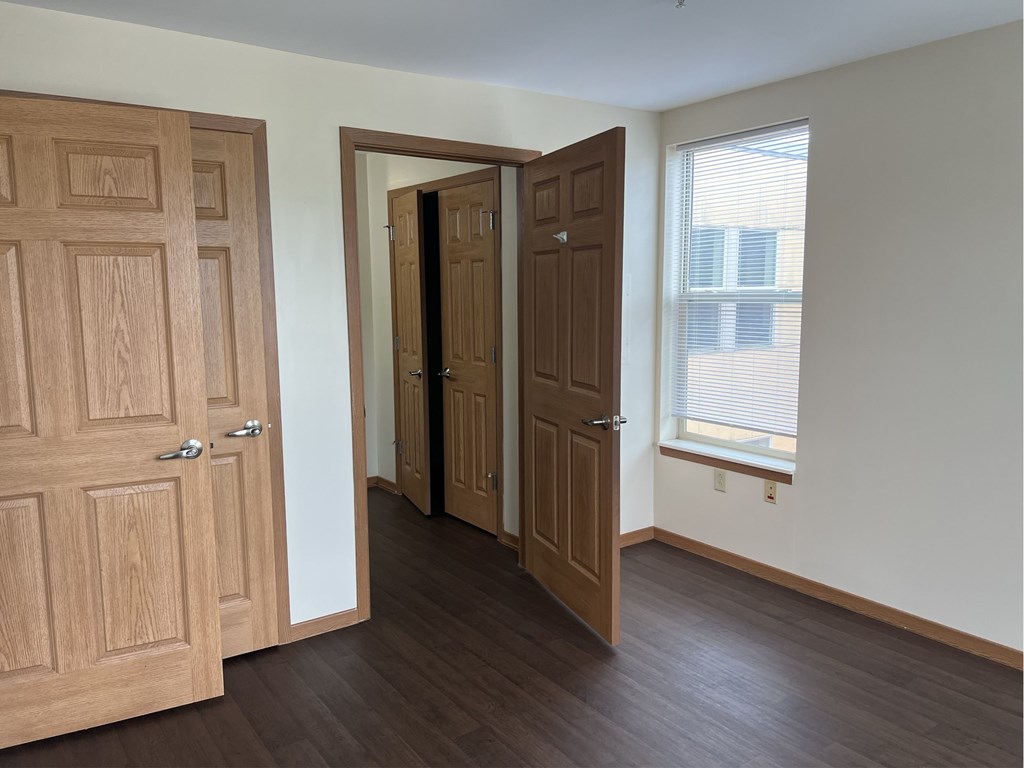 A room with two doors and a window.