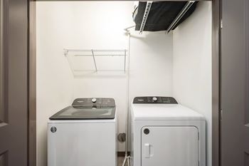 A small laundry room with a washer and dryer.