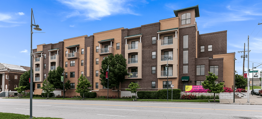 a large brick apartment building on a city street