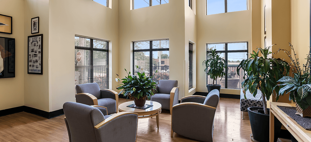 Jazz District apartments lobby with chairs and plants and a table