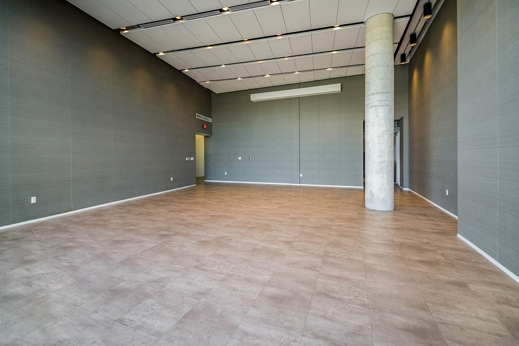 A large empty room with a pillar in the middle.