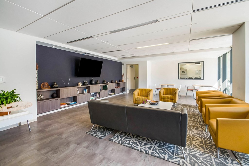 A modern waiting room with a long couch and chairs.