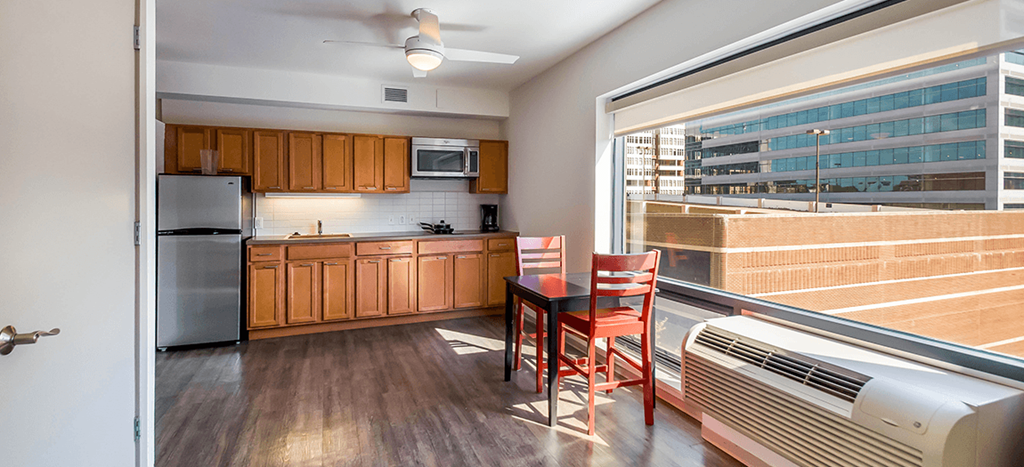 a kitchen with a table and chairs and a large window