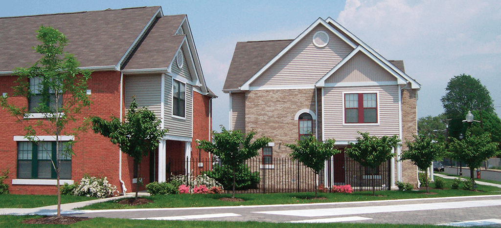 apartment homes with a fencing and lush landscaping at Lafayette Village Apartments