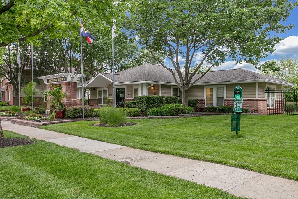 A house with a flag on the front lawn.