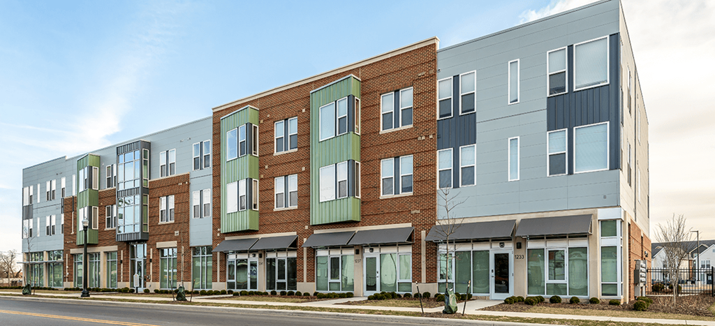 an apartment building on the side of a street