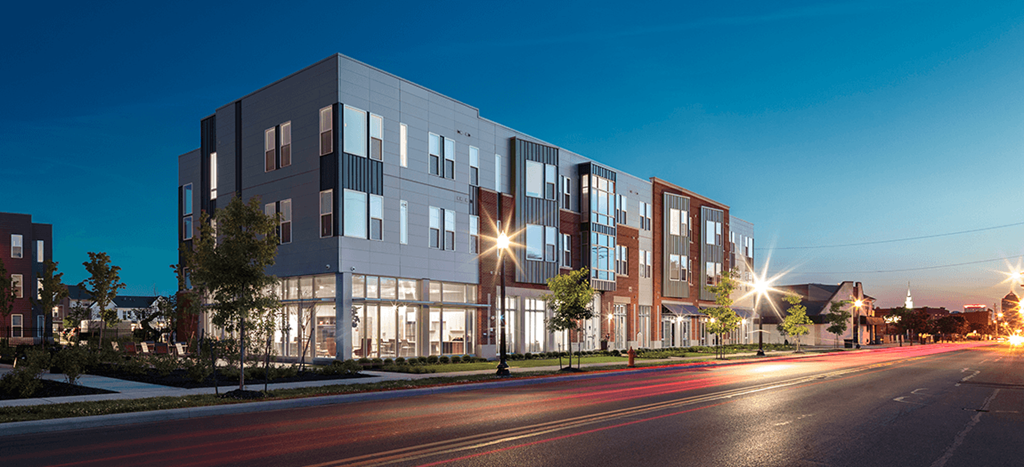 a rendering of a building on a city street at night