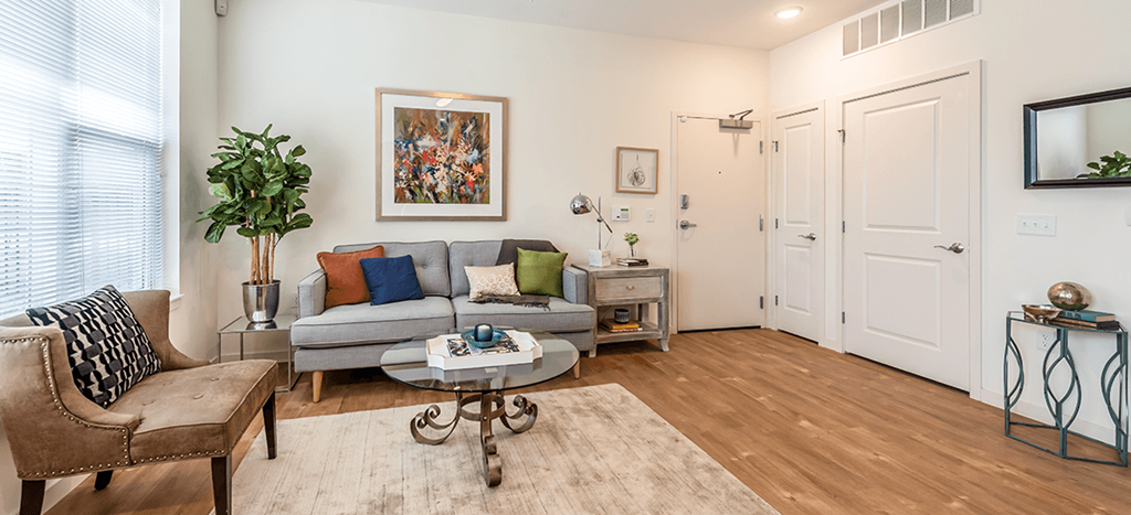 a living room with a couch and a coffee table at Legacy Pointe at Poindexter apartments