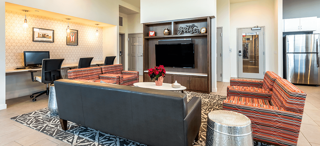 Legacy Pointe at Poindexter clubhouse with a couch and a television