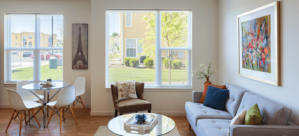a living room with a couch and a table with chairs at Legacy Pointe at Poindexter