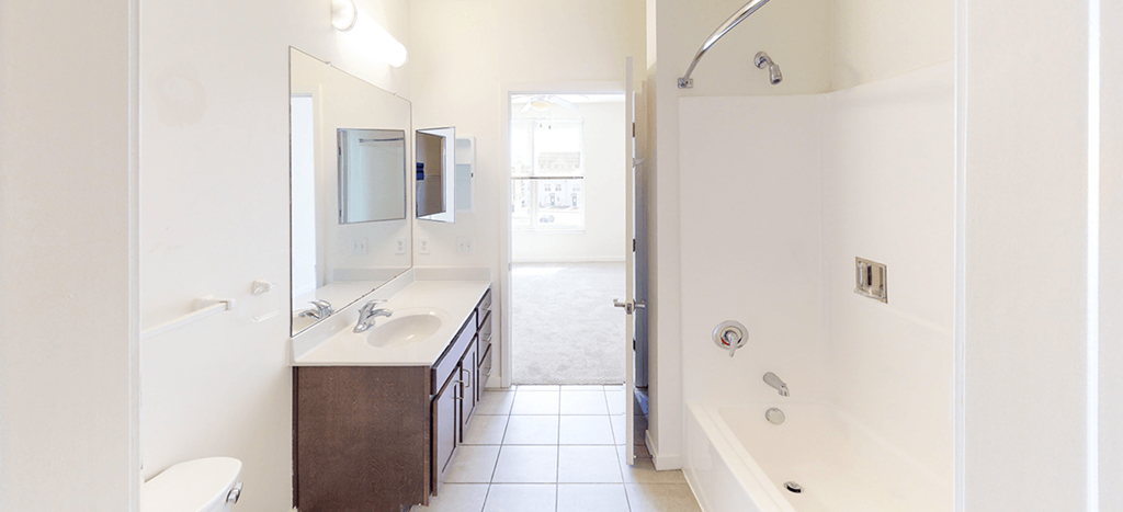 a bathroom with a shower and a sink and a mirror