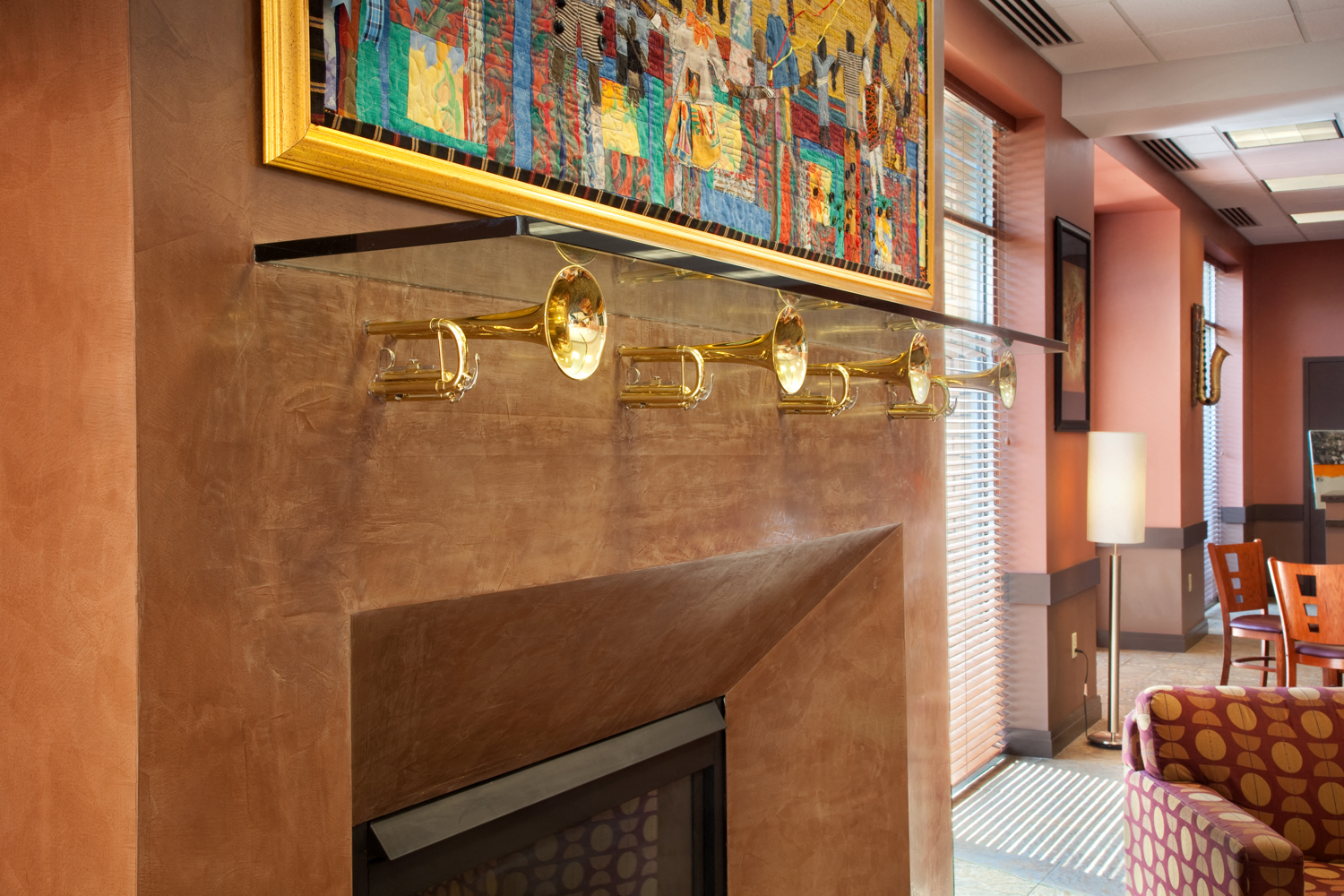 a living room with a fireplace and a painting above it