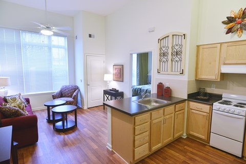 A kitchen with wooden cabinets and a white stove.