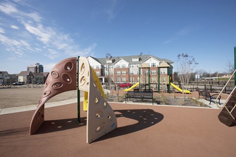 A playground with a slide and a play structure.