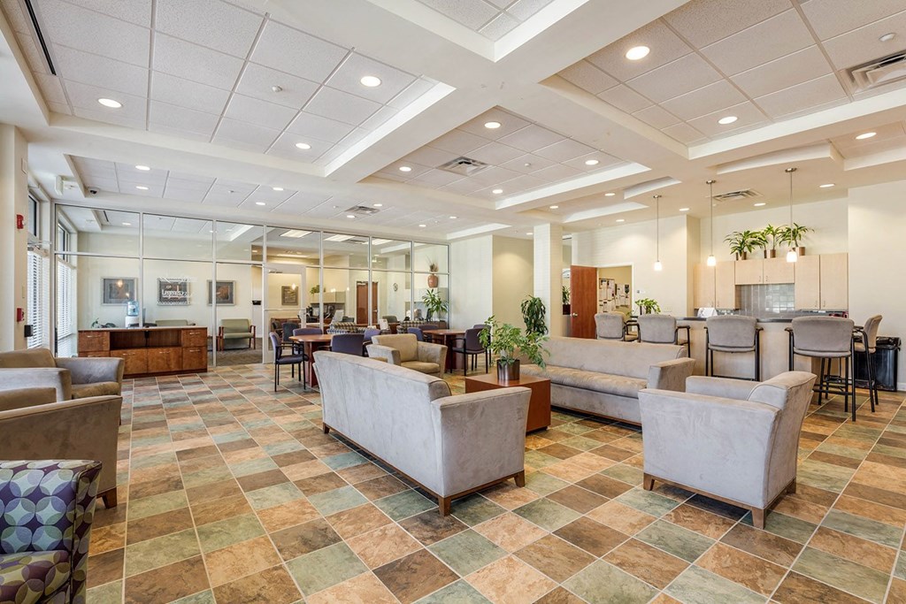 a large lobby with couches and chairs and tables