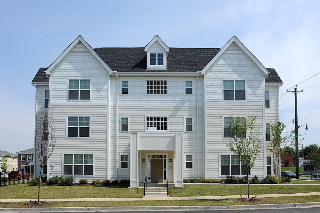 a white house on the side of a street