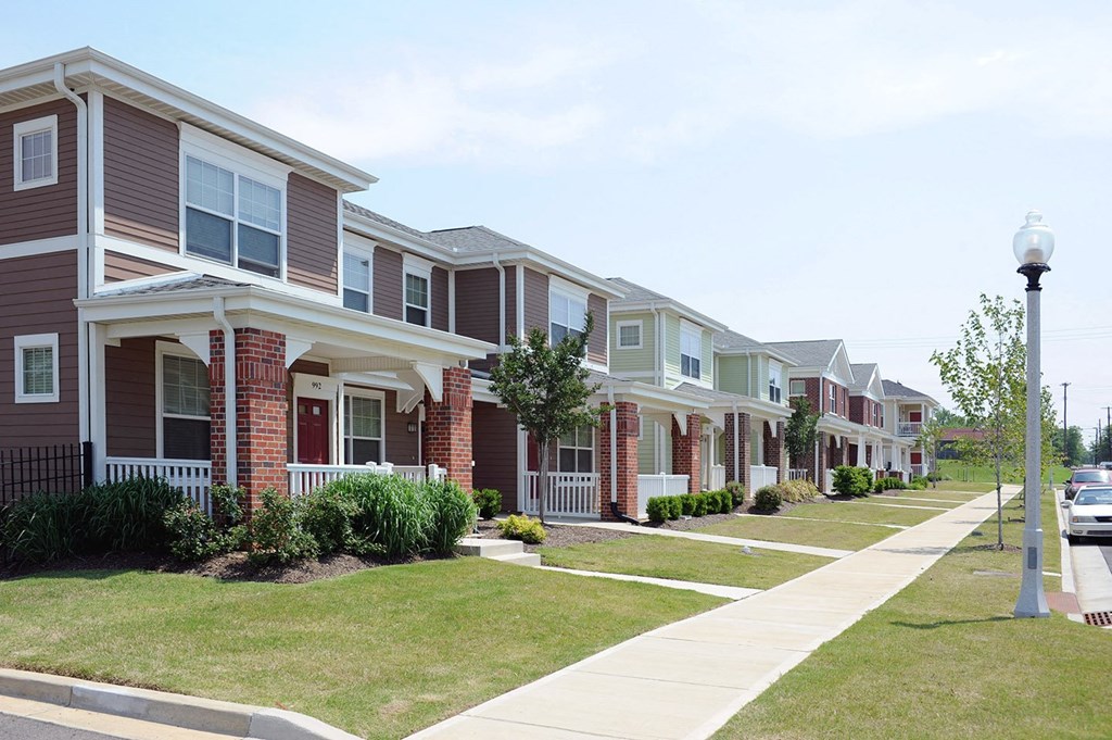 a row of suburban homes on a sidewalk