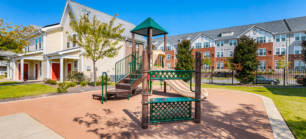 Legends Park Apartments playground with a slide and green roof